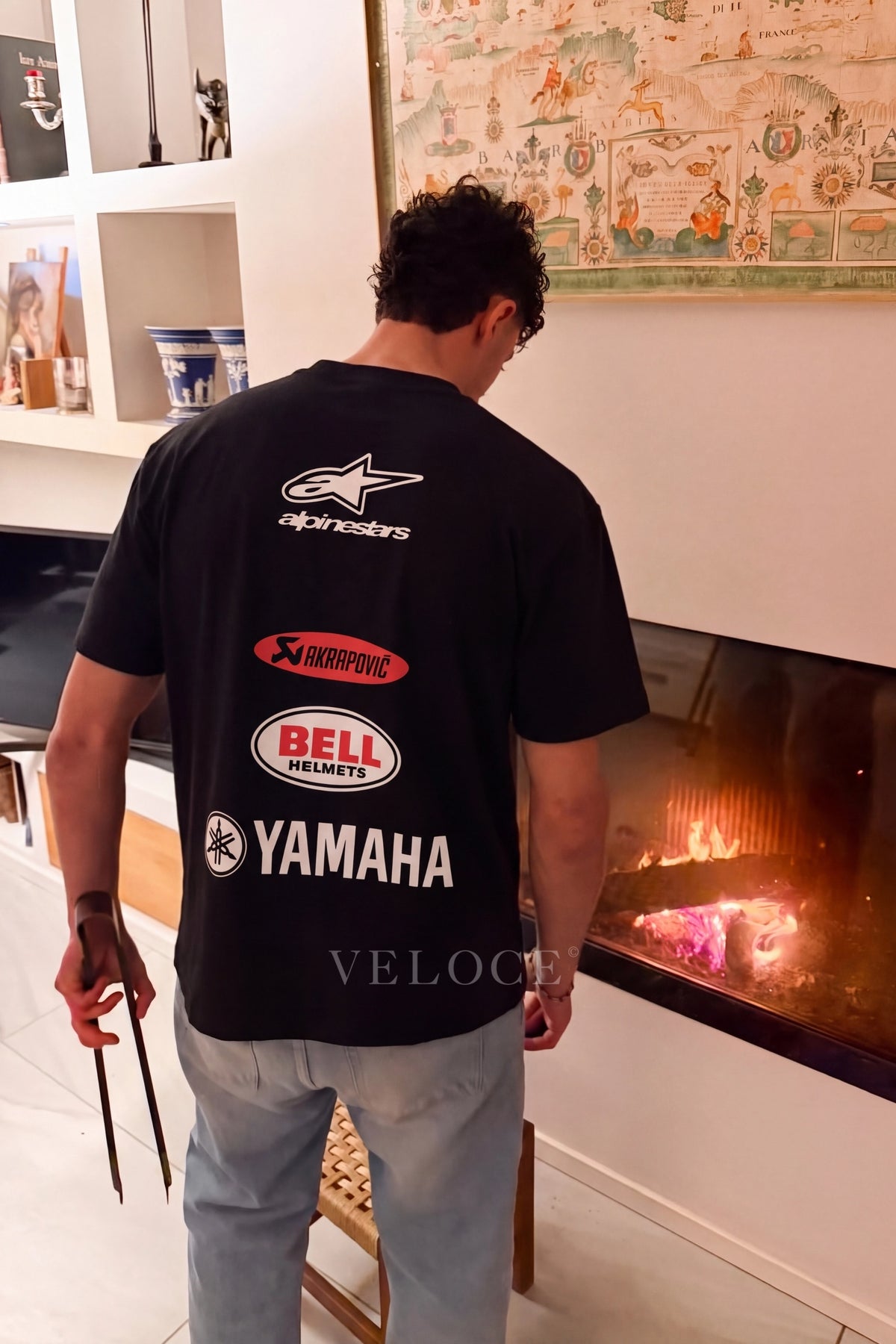 Man wearing the Alpinestars Racing T-Shirt from behind with the Akrapovic, Bell Helmets and Yamaha back print