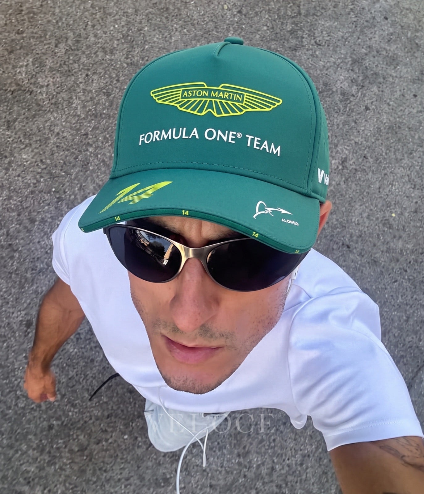 Man wearing the green Aston Martin F1 Fernando Alonso 2025 cap outdoors