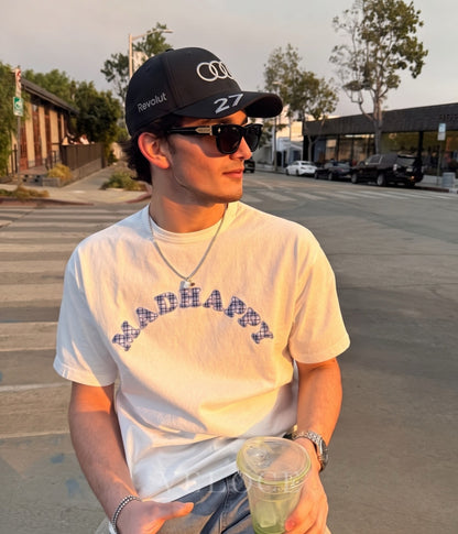 Man wearing the black Audi F1 Team 2026 embroidered cap at sunset