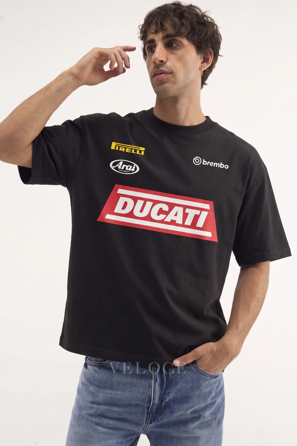 Man wearing the black Ducati Racing T-Shirt with the red Ducati block and Pirelli, Arai and Brembo logos