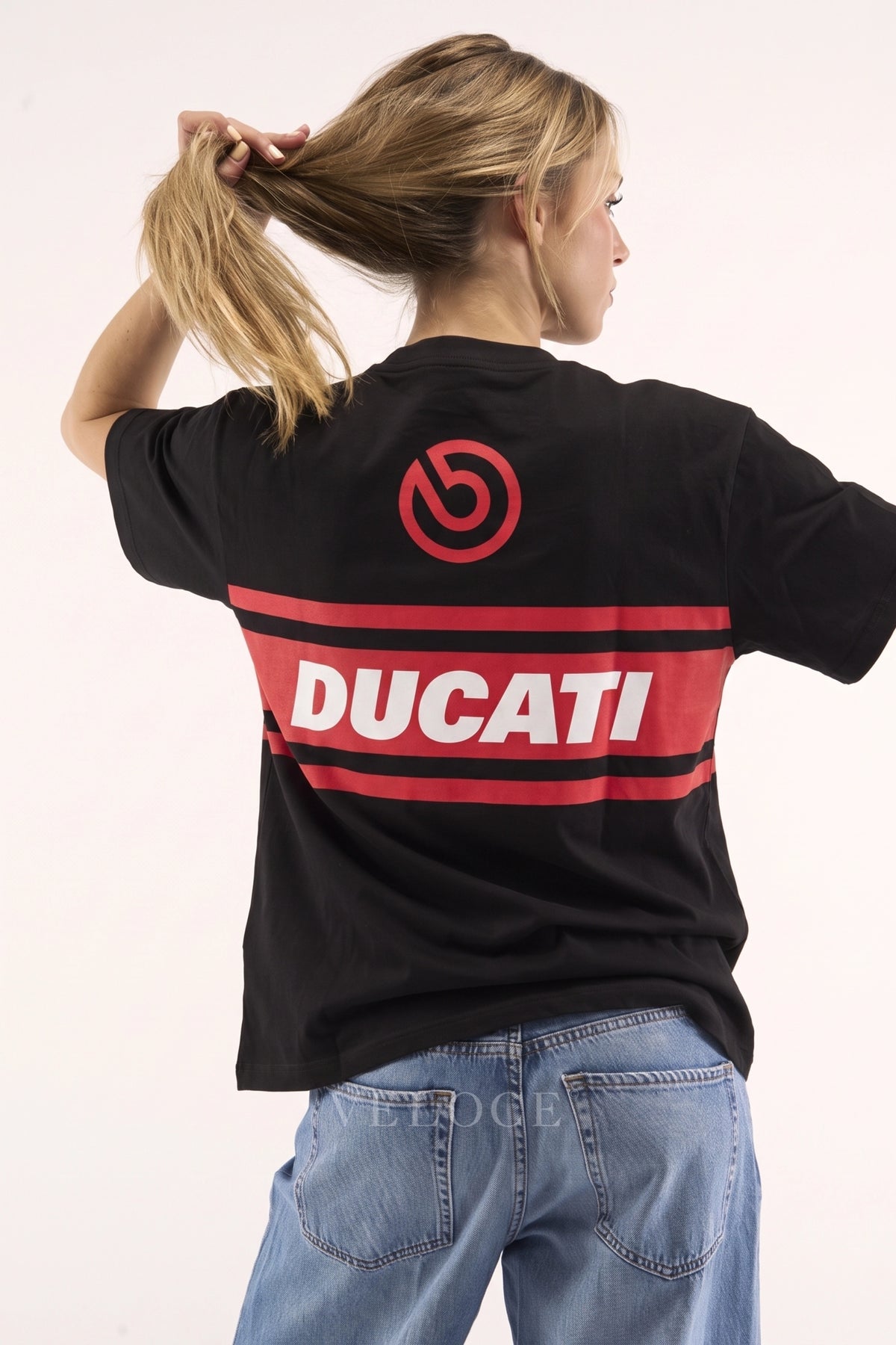 Woman wearing the Ducati Racing T-Shirt from behind, showing the Brembo roundel and red Ducati stripe