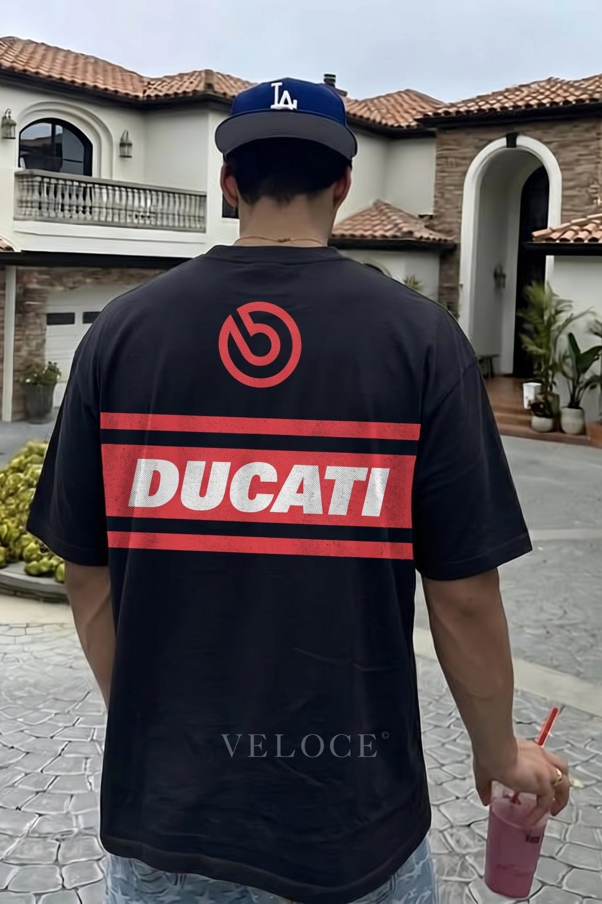Man walking outdoors wearing the Ducati Racing T-Shirt with the red Ducati back stripe