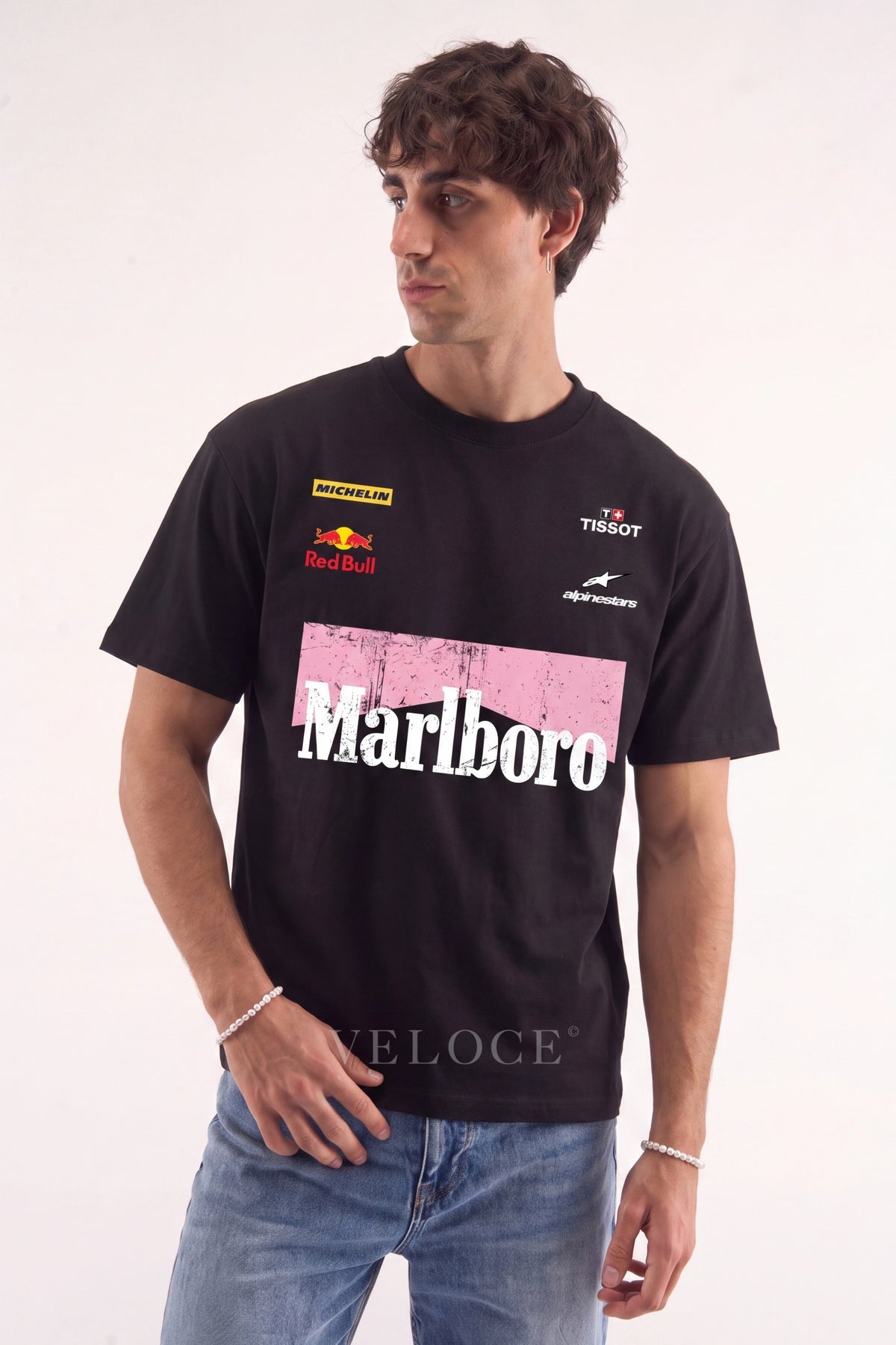 Man wearing the black Marlboro Racing T-Shirt with Michelin, Red Bull, Tissot and Alpinestars logos across the chest