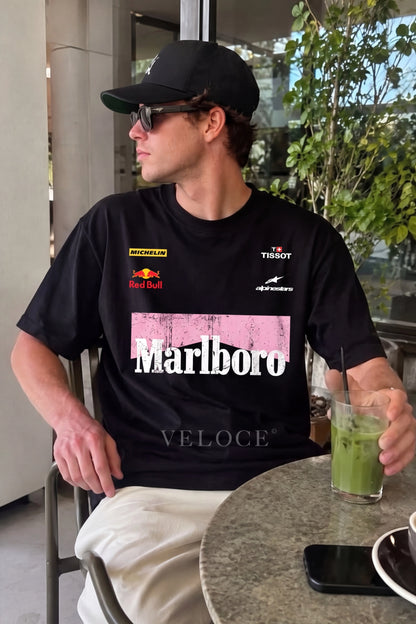Man in a cap wearing the Marlboro Racing T-Shirt at a cafe terrace