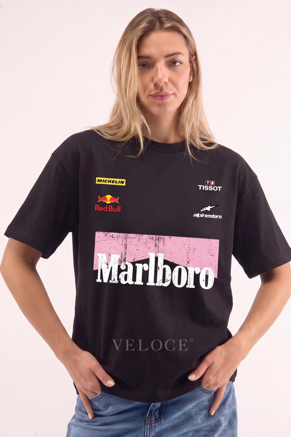 Woman wearing the oversized black Marlboro Racing T-Shirt with pink chevron and sponsor logos