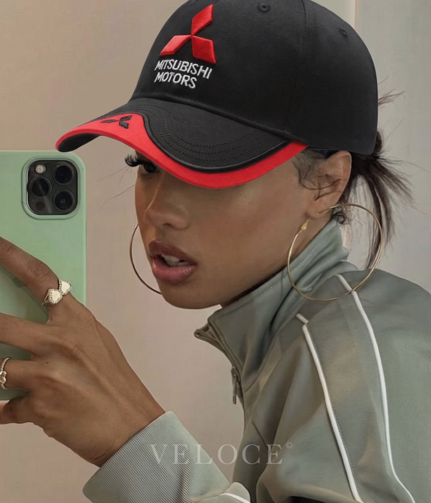 Woman wearing the black and red Mitsubishi Motors embroidered cap