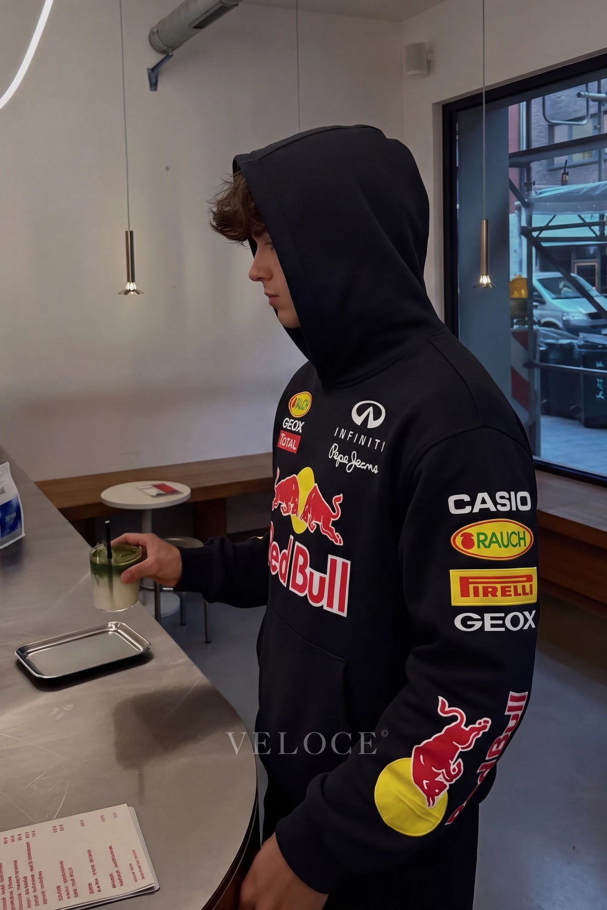 Red Bull Racing F1 embroidered hoodie worn indoors with the hood up