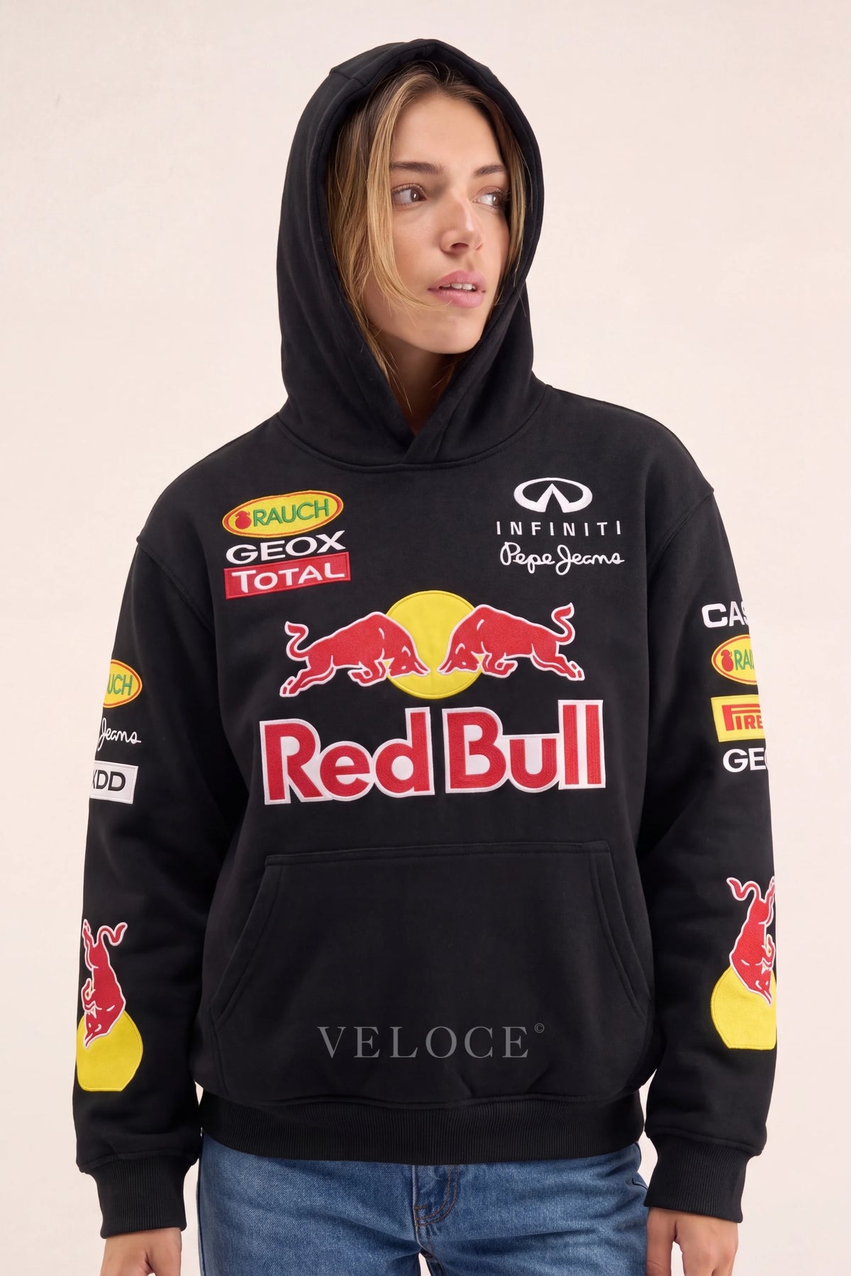 Woman wearing the Red Bull Racing F1 hoodie with the hood up, front view