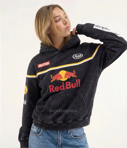 Red Bull Racing Hoodie black washed front view woman – vintage oversized motorsport sweatshirt with Red Bull logo, Motul and Arai Helmets patches, yellow stripe detail, kangaroo pocket