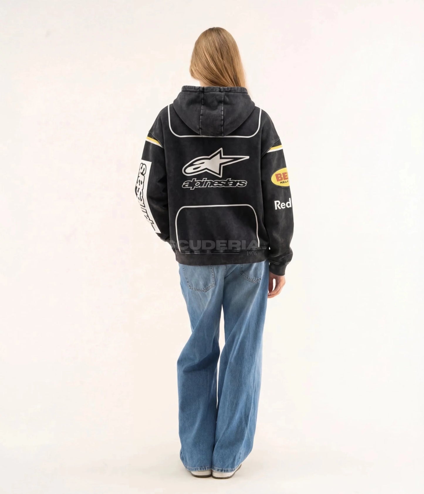 Red Bull Racing Hoodie black washed back view women – vintage oversized motorsport sweatshirt with Alpinestars, Bell Helmets and Red Bull logos on back, Alpinestars sleeve print, yellow racing stripe detail