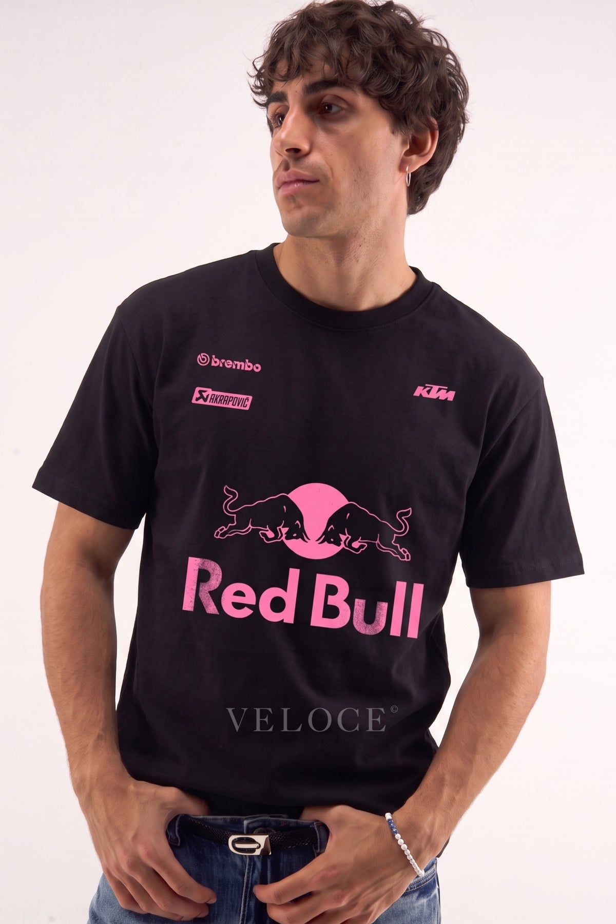 Man wearing the black Red Bull Racing T-Shirt with hot pink bulls and Brembo, KTM and Akrapovic logos