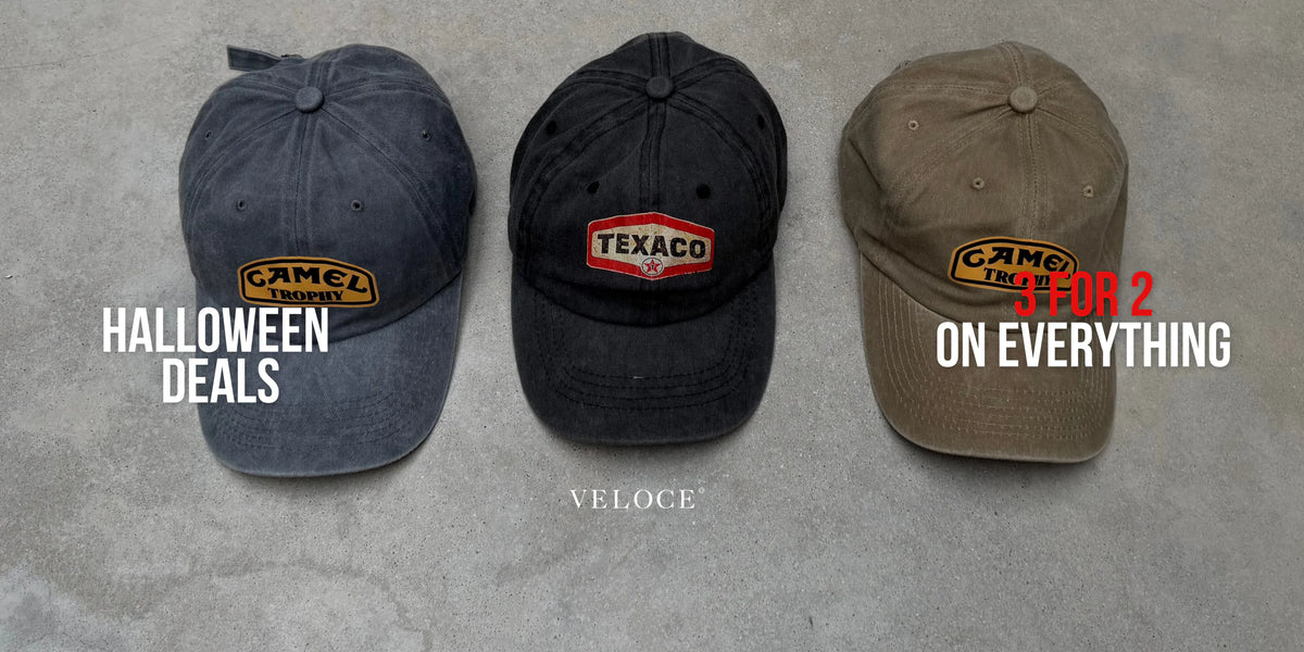 Three washed vintage caps - Camel Trophy, Texaco and Camel - laid on concrete - VELOCE Halloween deals, 3 for 2 on everything